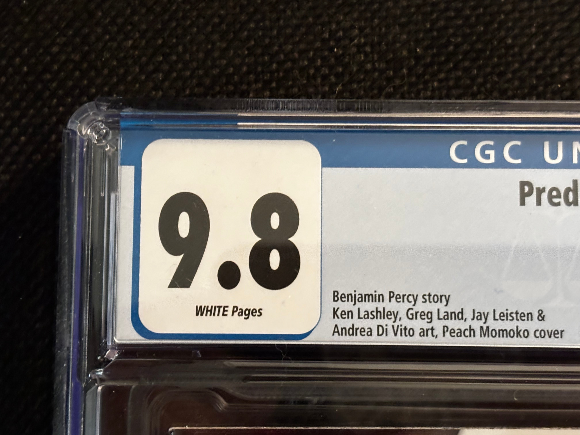 Comic book grading label with a score of 9.8 on a black background