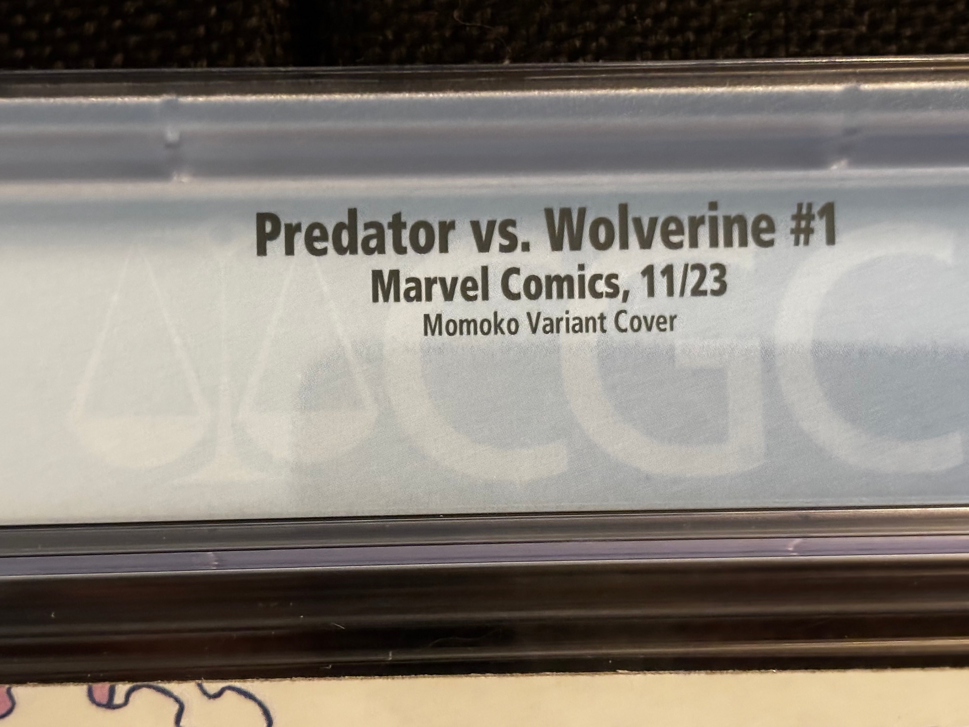 Comic book cover with text 'Predator vs. Wolverine #1' on a clear plastic sleeve.